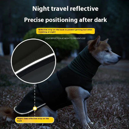 Dog wearing black reflective anti-anxiety soothing jacket with night travel reflective strip for safety and calming effects