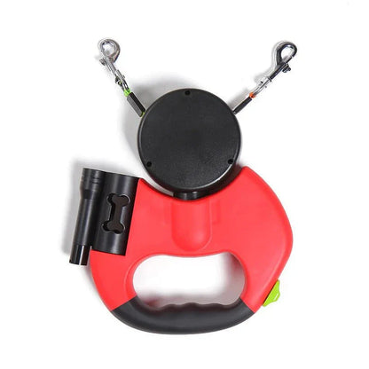 Red dual dog retractable leash with ergonomic handle, built-in LED flashlight, and dual independent controls for walking two dogs without tangles.